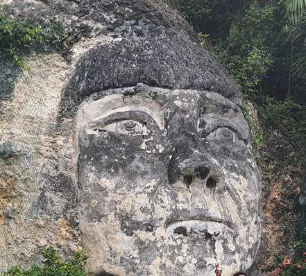 A person wearing a hat and sunglasses
Description automatically generated